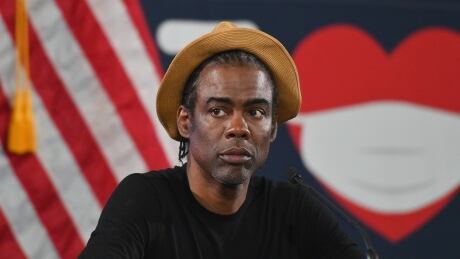 Actor/comedian Chris Rock speaks with NY Governor Andrew M. Cuomo and actress Rosie Perez during a press briefing on COVID-19 at Madison Boys and Girls Club in the Brooklyn borough of New York City on May 28, 2020. 1215851250