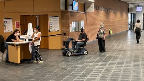 People wait in line on voting day at the London Public Library on Dundas Street to cast their ballot. London polling station