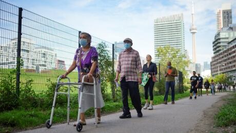 People line up outside a polling station to vote in Canada's federal election, in Toronto, Ont., on Sept. 20, 2021. CANADA-ELECTION/