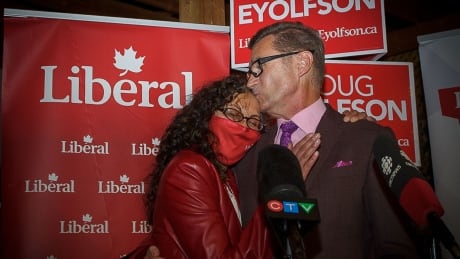 Charleswood-St. James-Assiniboia-Headingley Liberal candidate Doug Eyolfson hugs his wife, Sowmya Dakshinamurti, as he delivers a speech to supporters on Monday, Sept. 20, 2021, in St. James. The federal election race between Eyolfson and Conservative incumbent Marty Morantz will come down to mail-in ballots, to be counted starting Tuesday at 9 a.m. Liberal candidate Doug Eyolfson at campaign headquarters Sept 20 2021