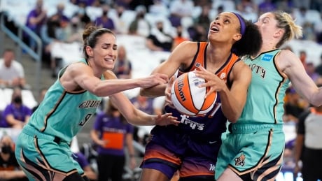 Phoenix forward Brianna Turner, center, is fouled by New York guard Rebecca Allen (9) as teammate Sami Whitcomb, right, defends during the first half of the Mercury's 83-82 win over the Liberty in the first round of the WNBA playoffs on Thursday. turner-brianna-092421