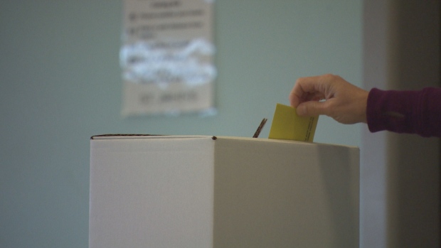 Mayors, councillors elected in some N.W.T. hamlets; A voter drops their ballot into a ballot box for the 2021 St\. John's municipal election\.