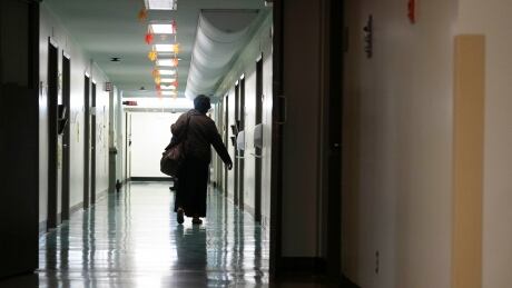 Generic images of Jean-Talon Hospital in Montreal. Photo taken at Jean-Talon Hospital, Montreal, Quebec. Pictured: nurses, staff, red zone, cleaning, attendant, hospital, hospitals. Taken 14 Oct 2021. See people in hallway, shot from behind. Jean-Talon Hospital, Montreal