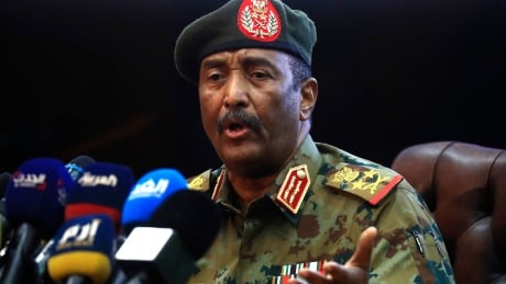 Sudan's top army general Abdel Fattah al-Burhan speaks during a press conference at the General Command of the Armed Forces in Khartoum on October 26, 2021. - Angry Sudanese stood their ground in street protests against a coup, as international condemnation of the military's takeover poured in ahead of a UN Security Council meeting. 1236139297