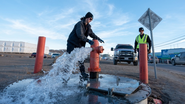 Disagreements between city, territory slowed Iqaluit water crisis response: report; Members of the Iqaluit Fire Department assist with flushing the city's water pipes in Iqaluit, Nunavut, on Wednesday, Oct\. 27, 2021\. According to a City of Iqaluit news release issued earlier in the day, flushing will conclude by Thursday\. 