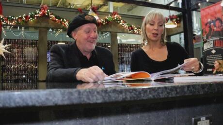 Chris Edwards, left, and Elaine Weeks, right, look at their latest book in Walkerville Brewery. Chris Edwards