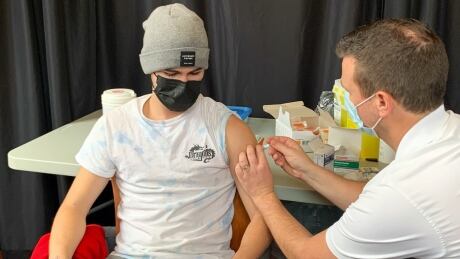 Acadia University student Carter Theriault gets a dose of the meningitis B vaccine on Friday as part of the B for Kai program. acadia Carter Theriault