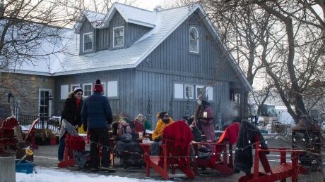 People enjoy drinks on the outdoor patio set up at the Cheshire Cat pub in the community of Carp in rural west Ottawa on Jan. 6, 2022, during the COVID-19 pandemic. outdoor winter patio cheshire cat carp COVID-19 pandemic ottawa