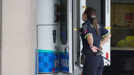 A paramedic talks to a colleague inside an ambulance parked outside the emergency department at University Hospital in London, Ont. in January 2021. Covid London