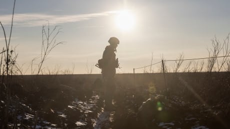An Ukrainian soldier walks on the line of separation from pro-Russian rebels, in Mariupol, Donetsk region, Ukraine, Thursday, Jan. 20, 2022. President Joe Biden has warned Russia's Vladimir Putin that the U.S. could impose new sanctions against Russia if it takes further military action against Ukraine. U.S. Secretary of State Antony Blinken is warning of a unified, "swift, severe" response from the United States and its allies if Russia sends any military forces into Ukraine. United States Ukraine