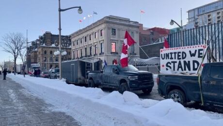 Trucks parked on Wellington Street in front of Parliament Hill in Ottawa early Jan. 28, 2022. Part of a convoy protesting COVID-19 rules, including the vaccine mandate for cross-border truckers, are expected in Ottawa later that day with a larger rally expected Saturday. trucker convoy protest ottawa