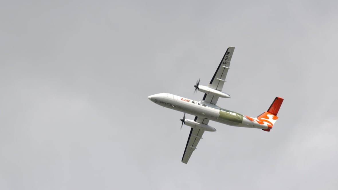A photo of an Air Inuit air plane from the ground.