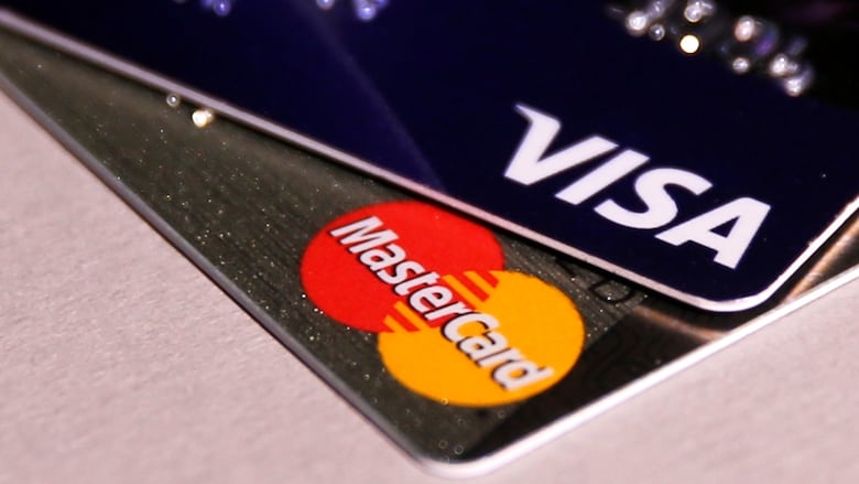 Visa and MasterCard credit cards lay on a table.
