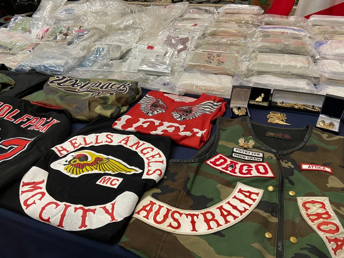 Hells Angels patches and paraphernalia are displayed on a table.