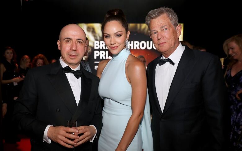 Music producer David Foster, right, arranged for the royal couple to stay at the secluded mansion. His wife, singer Katharine McPhee, centre, is longtime friends with Meghan Markle. A trust set up by billionaire tech investor Yuri Milner, left, bought the estate in 2013. (Kelly Sullivan/Getty)