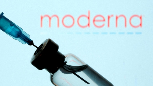 Moderna is banking on a combined COVID, flu and RSV vaccine. Will it work?; FILE PHOTO: A vial and sryinge are seen in front of a displayed Moderna logo in this illustration taken January 11, 2021. 