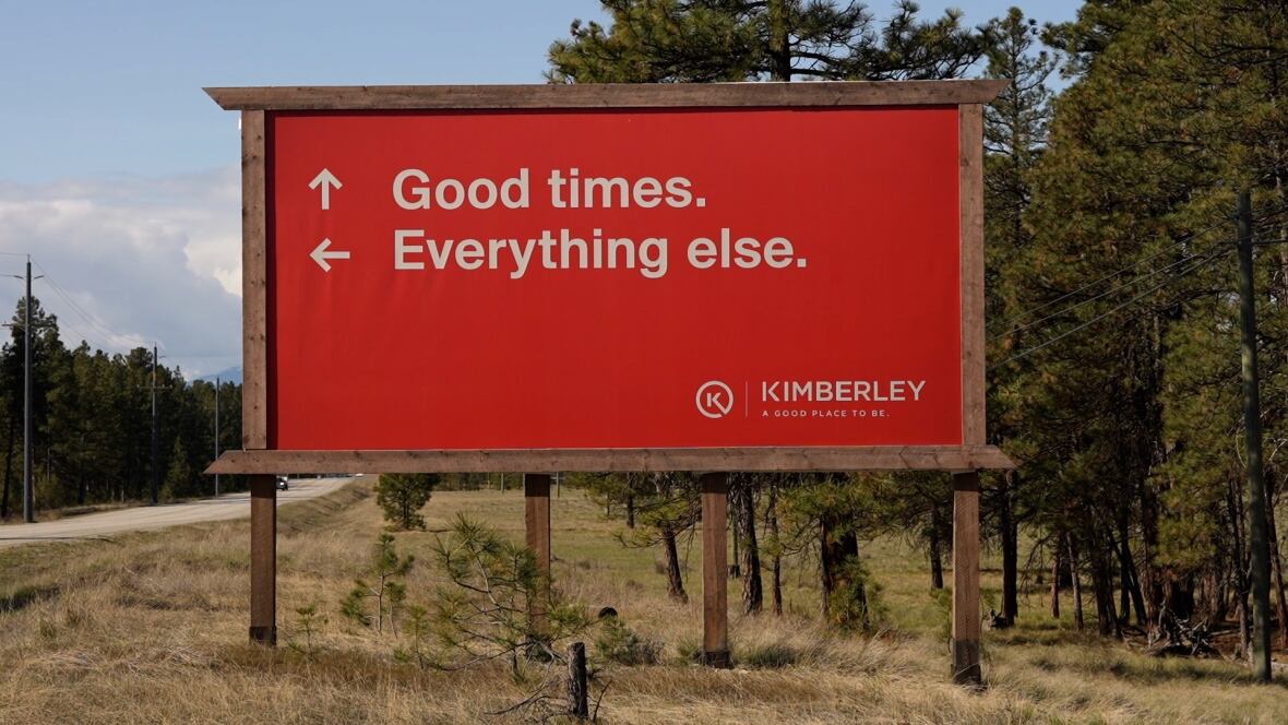 A red roadway sign with an arrow pointing forward saying 'Good times ahead' and an arrow pointing to the left saying 'Everything else.'
