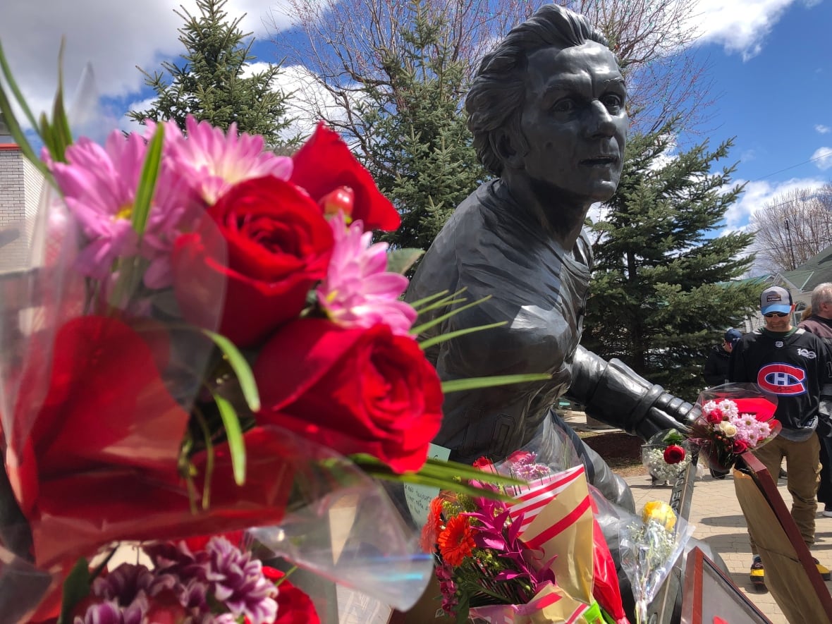 A statue of Guy LaFleur with roses sees in the foreground.