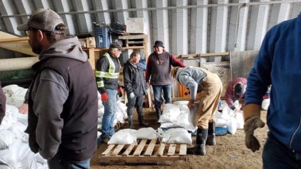 Minnedosa crews scrambling to hold back flood waters with more rain on the way