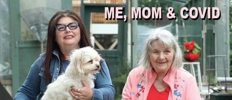 A woman with glasses holds a dog while her sister stands to her left. The words Me, Mom & Covid appear at the top.
