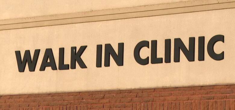 Sign on building says Walk In Clinic.