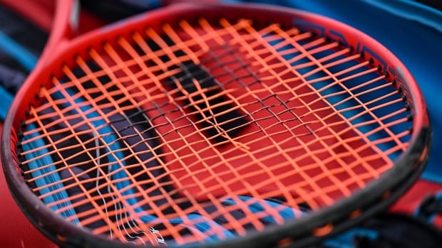 Dutch tennis coach Max Wenders was suspended for 12 years over match-fixing on Wednesday. A red and black tennis racket.