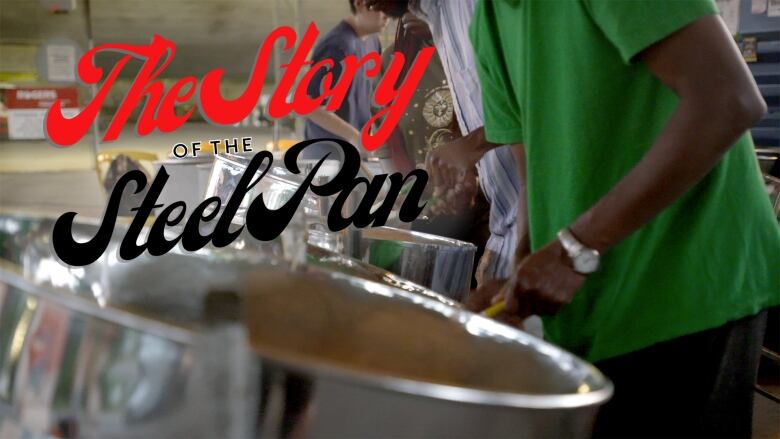 Film still of a steel pan drum. Text overtop of the photographic images reads in red and black script: "the story of the steel pan."