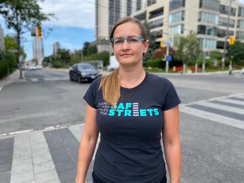 Jessica Spieker stands in front of a crosswalk near St. Clair Ave. West and Spadina Road. She was riding her bike in 2015 when she was struck by a woman driving an SUV. Now, she wants Ontario's Chief Coroner to look into the number of road deaths caused by large vehicles like SUVs and pickup trucks.