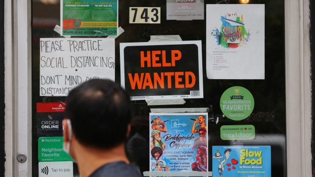 Immigration prevented a recession last year, but looming changes could stall growth: economists; A pedestrian passes a "Help Wanted" sign in the door of a hardware store in Cambridge, Massachusetts, U\.S\., July 8, 2022\.   REUTERS/Brian Snyder