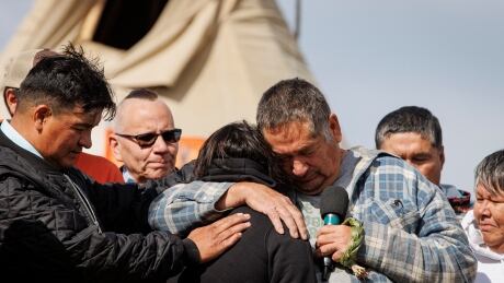 Darryl Burns, right, puts his arm around Skye Sanderson during a news conference at James Smith Cree Nation on Sept. 8, 2022. Sanderson was the wife of Damien Sanderson, who was charged in relation to the stabbing deaths of 10 people, including Burn’s 61-year-old sister Gloria. JAMES SMITH CREE NATION PRESSER