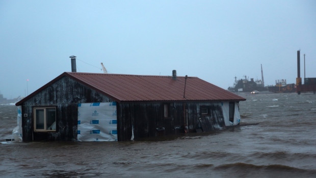 'Never this severe': Alaska residents flee from flooding as powerful storm slams state; A home is seen floating in the Snake River near Nome, Alaska, on Saturday, Sept. 17, 2022. Much of Alaska's western coast could see flooding and high winds as the remnants of Typhoon Merbok moved into the Bering Sea region. The National Weather Service says some locations could experience the worst coastal flooding in 50 years. (AP Photo/Peggy Fagerstrom)