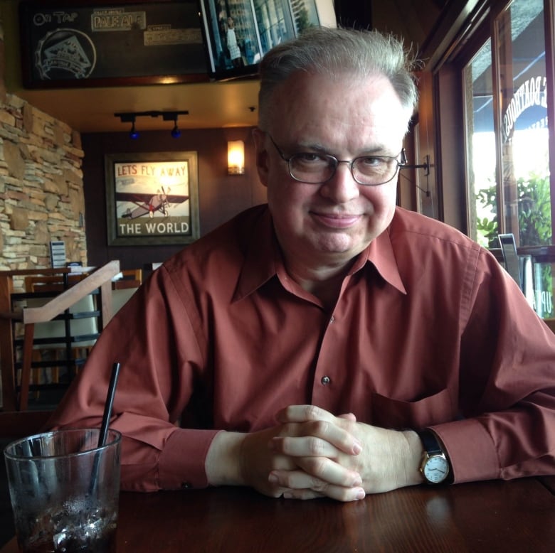 Marc Mentzer pictured sitting a table with a drink beside him. 