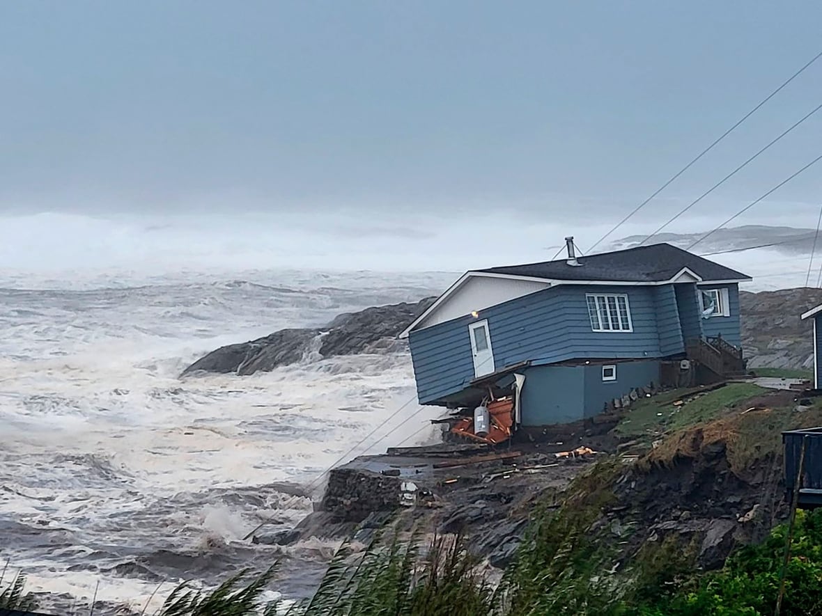 A house fights against high winds due to a tropical storm Fiona. The house will later fall into the sea.
