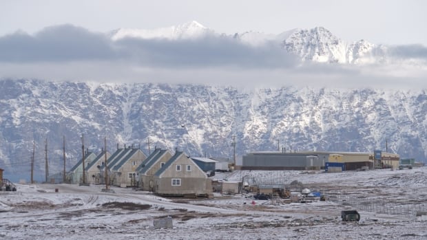 Buildings, fog, snowcapped mountains.