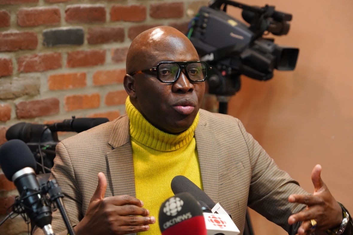 A man speaks behind the microphone.