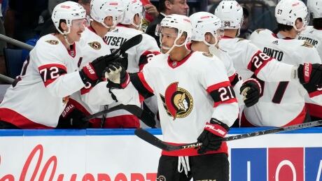 Ottawa Senators close helping Mathieu Joseph (21) celebrates with the seat aft his extremity against the Tampa Bay Lightning during the 2nd play of an NHL hockey crippled Tuesday, Nov. 1, 2022, successful Tampa, Fla. Senators Lightning Hockey