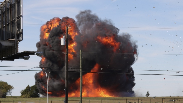 WW II-era planes collide mid-air at Dallas air show; In this photo provided by Nathaniel Ross Photography, a historic military plane crashes after colliding with another plane during an airshow at Dallas Executive Airport in Dallas on Saturday, Nov. 12, 2022. (Nathaniel Ross Photography via AP)