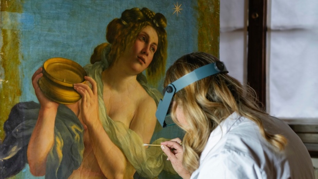This 1616 self-portrait was originally a nude. Then a man had it covered up ; Restorer Elizabeth Wicks works on the "Allegory of Inclination", a 1616 work by Artemisia Gentileschi, in the Casa Buonarroti Museum, in Florence, Italy, Wednesday, Nov. 9, 2022. Restorers have begun a six-month project on the "Allegory of Inclination" using modern techniques including x-rays and UV infrared research to go beneath the veils painted over the original to cover nudities and discover the work as Gentileschi painted it. (AP Photo/Andrew Medichini)
