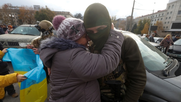 Kherson's liberation and the long road of healing ahead; A woman embraces a Ukrainian service member in the city centre after Russia's retreat from Kherson, Ukraine November 16, 2022.  