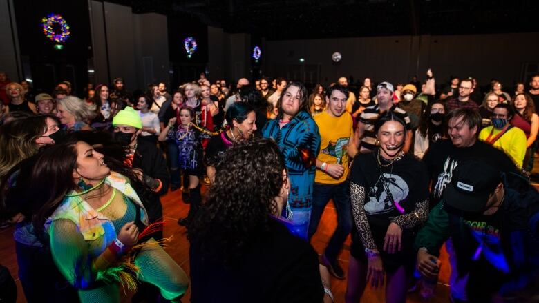 A large crowd gathered on a dance floor. 
