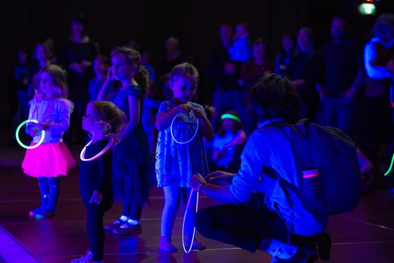 A group of children holding glowing rings. 