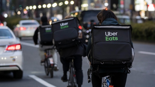 Why better tips could mean faster delivery when ordering from apps; TOKYO, JAPAN - APRIL 11: Uber Eats delivery men ride bicycles through the Kabukicho entertainment area on April 11, 2020 in Tokyo, Japan. Tokyo Governor Yuriko Koike has requested that businesses including schools, athletic facilities, bars and restaurants to temporarily close or operate under reduced hours. The action follows a state of emergency that covers 7 of Japans 47 prefectures as the Covid-19 coronavirus outbreak continues to spread throughout the country. (Photo by)