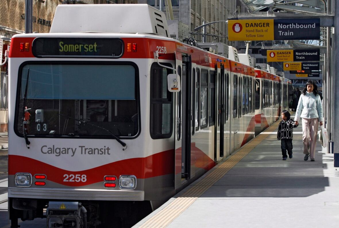 A close-up of a red and white Calgary transit train heading to Somerset.