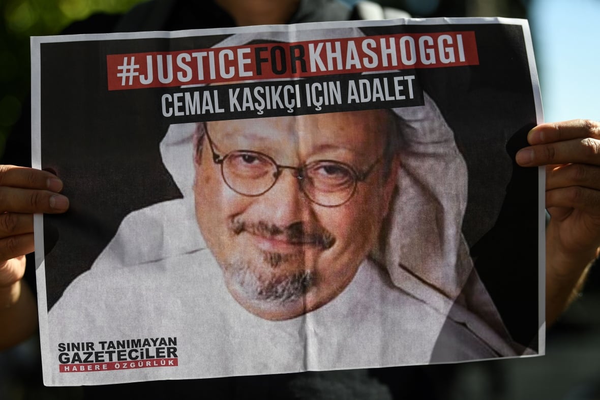 Handyan holds a picture of a man, with the words of justice for a rush on top.