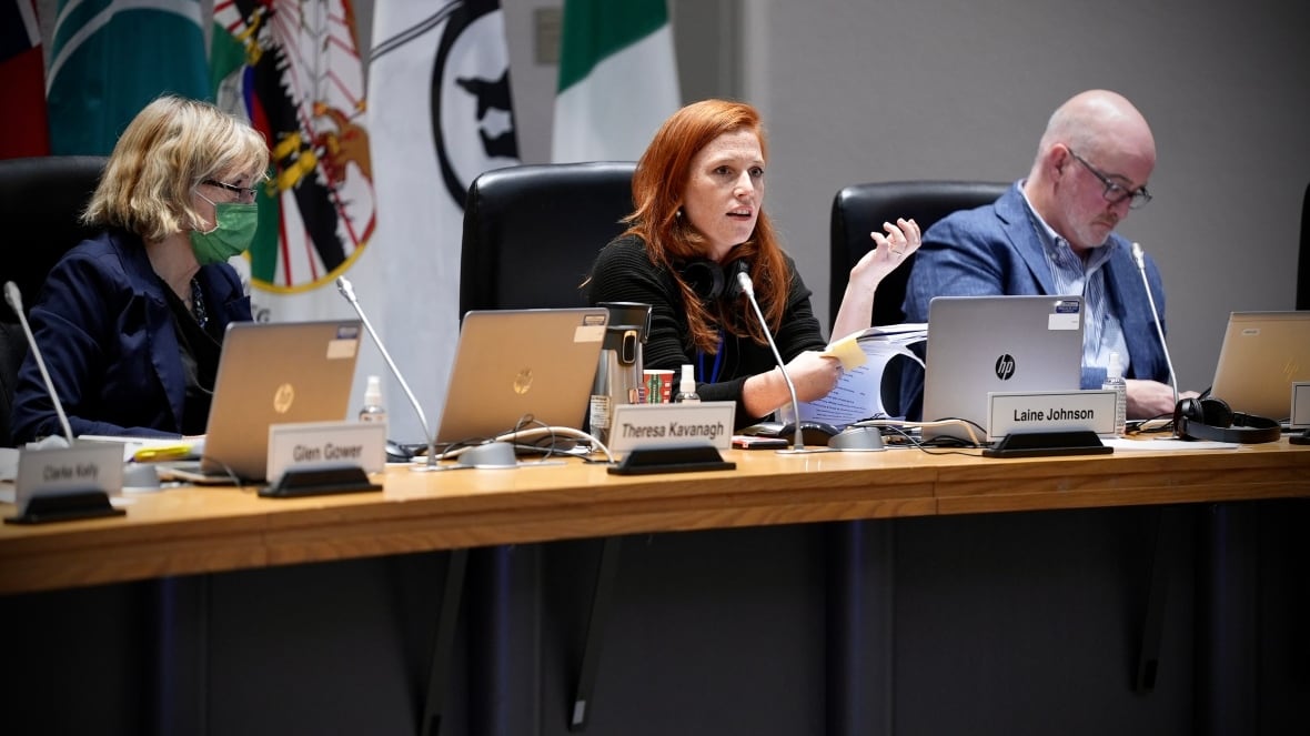 Three city councillors sit at a meeting table.