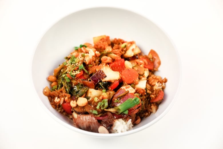 The vegan Hunan kung pao dish from Earls contains ginger soy sauce, wok fried vegetables, rice and peanuts. 