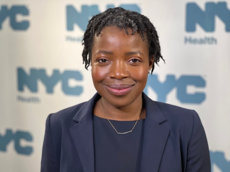 A fresh faced woman smiling at the camera. 