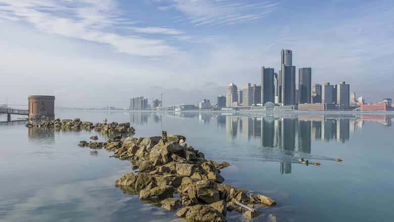 The Detroit skyline and Detroit River are pictured here. 