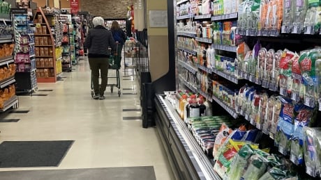 Person walks down a grocery aisle
