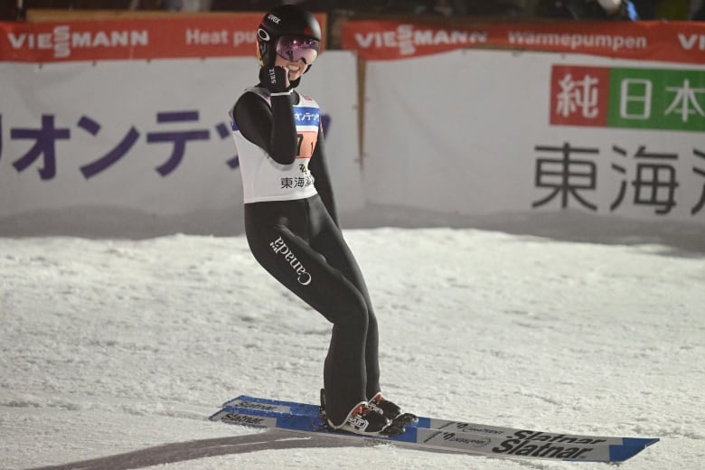 Alexandria Loutitt of Canada celebrates by lifting up her right fist during the World Cup normal hill super team event in Yamagata, Japan.